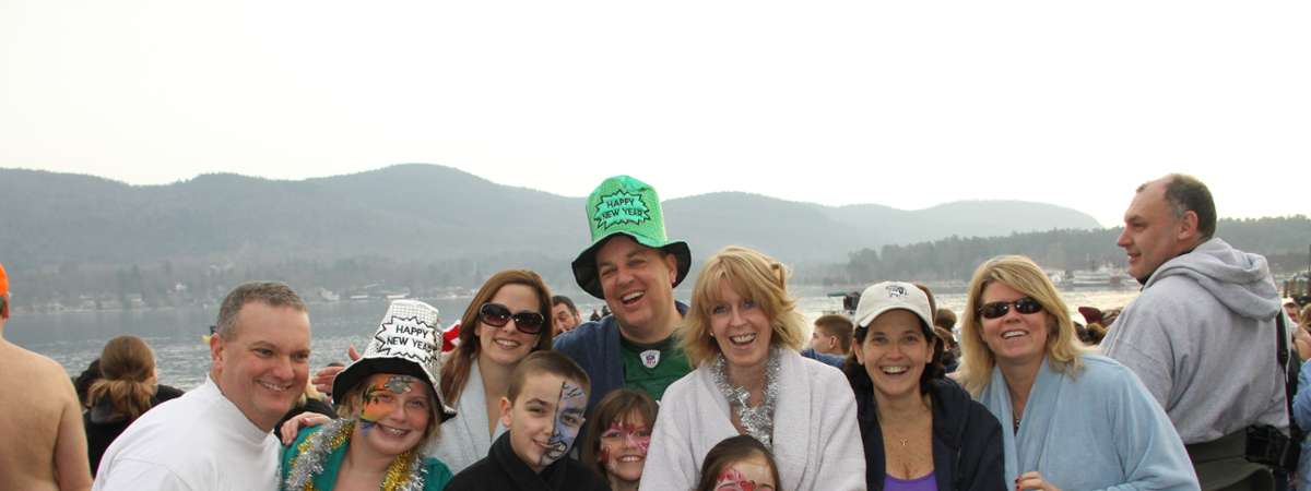 people in costumes and warm clothes are a polar plunge