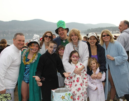 people in costumes and warm clothes are a polar plunge