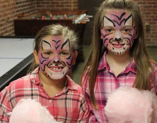 girls at ticonderoga end of winter carnival with faces painted like tigers