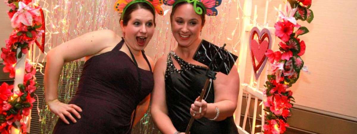 two women under arch at a mom prom