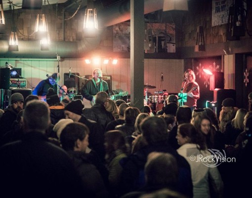 band performing in front of crowd inside
