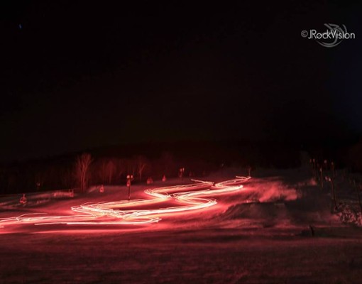 bright red lights on a snowy field in evening
