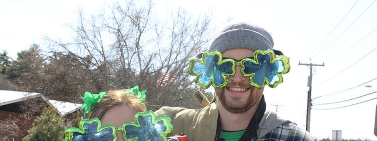 a man and woman with shamrock glasses
