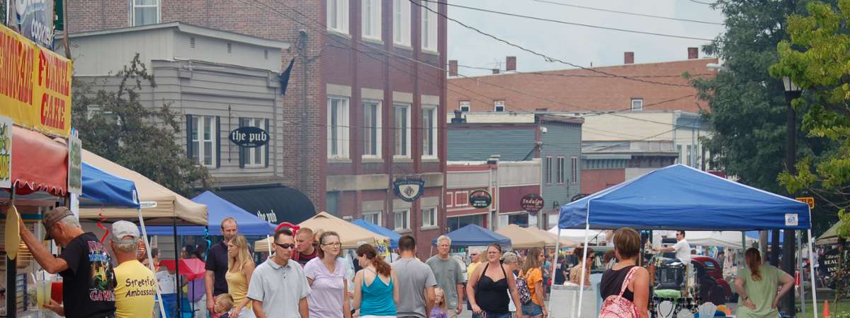 a large group of people on the street for Streetfest in Ticonderoga