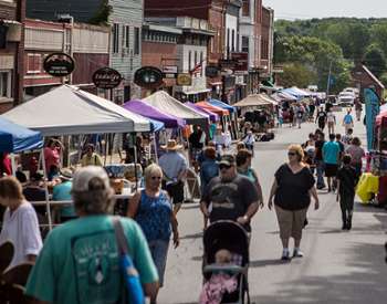 crowd walking through street festival