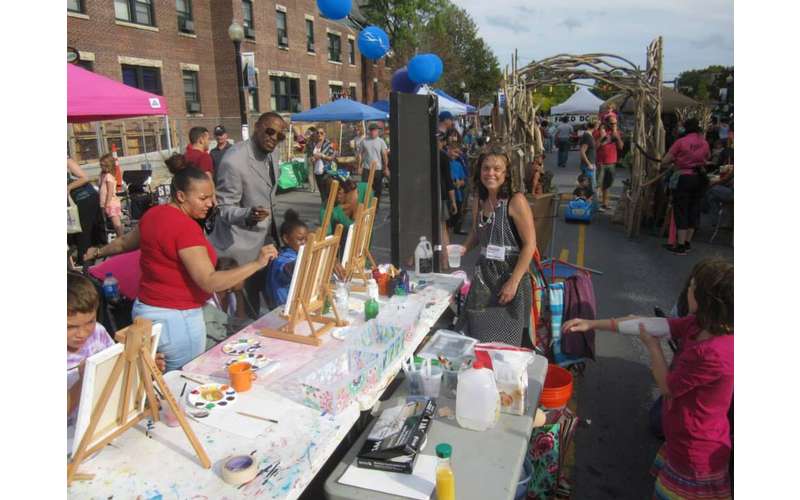 a street fair with people paitning