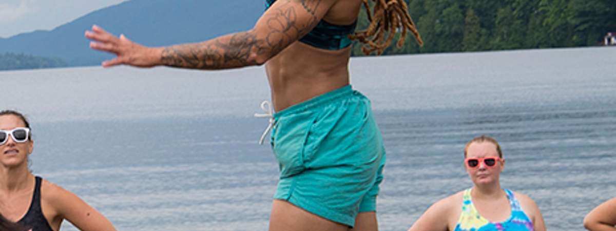 woman hitting volleyball on beach