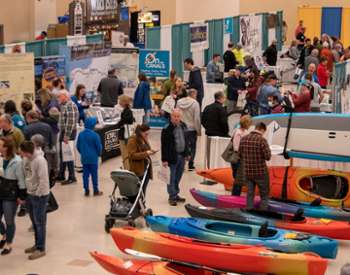 people exploring an indoor sports expo