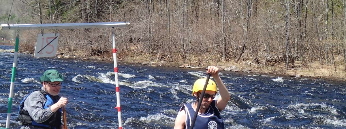 two paddlers going through a gate