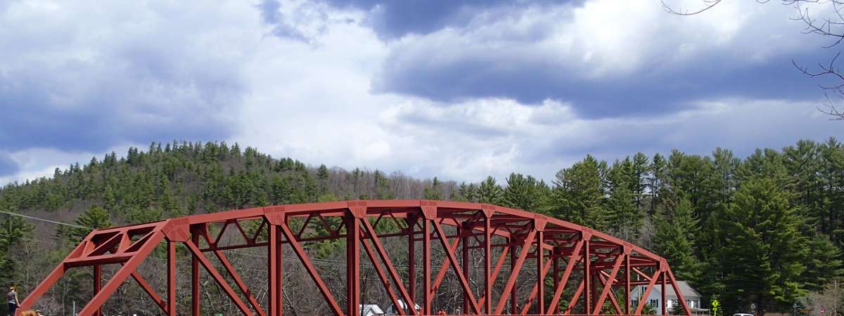 bridge with canoes and kayaks in front of it