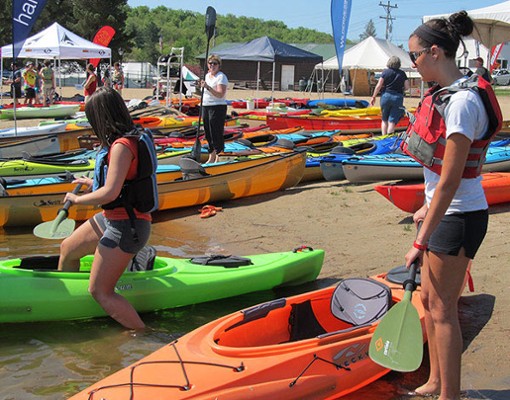 people standing near kayaks for demos