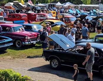 crowds and cars at car show in park
