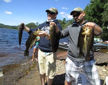 two people holding up fish