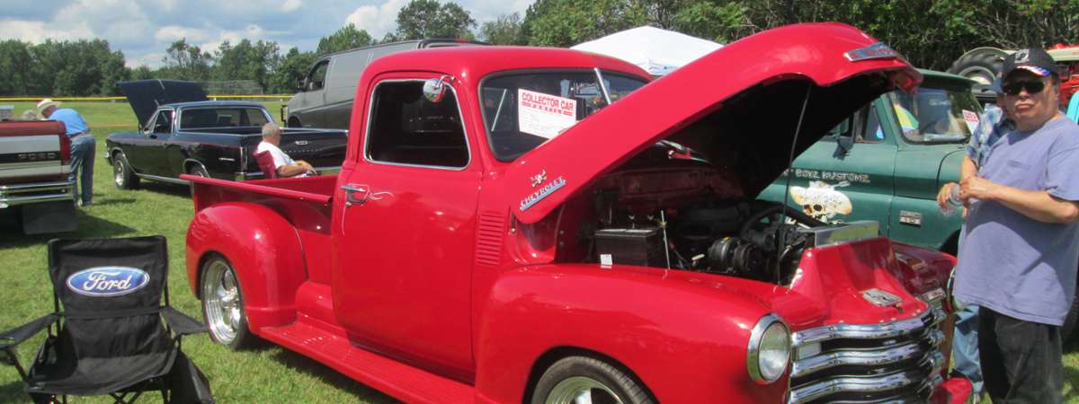 classic red truck with hood open