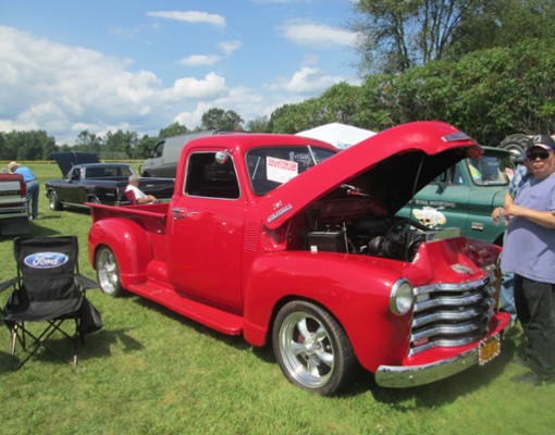 classic red truck with hood open