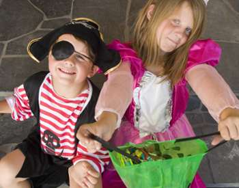 two costumed kids - boy pirate and girl princess