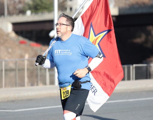 man running in race with a flag