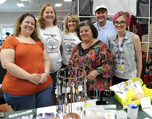 group of women posing by jewelry