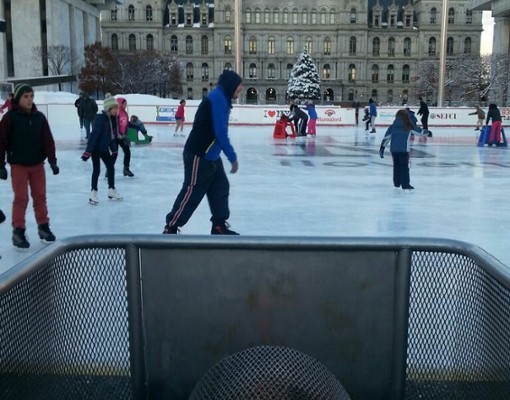 people skating in front of the plaza with some sort of fire in the foreground