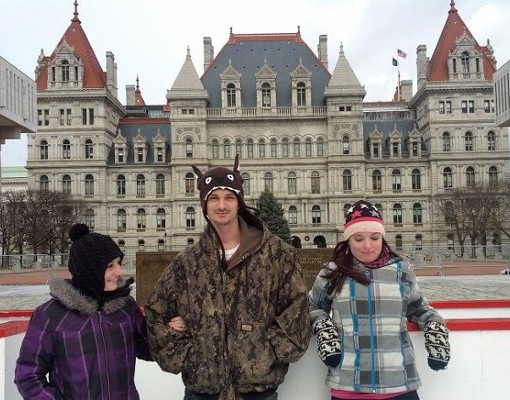three people at an ice rink