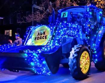 tractor lit up in blue int ractor parade