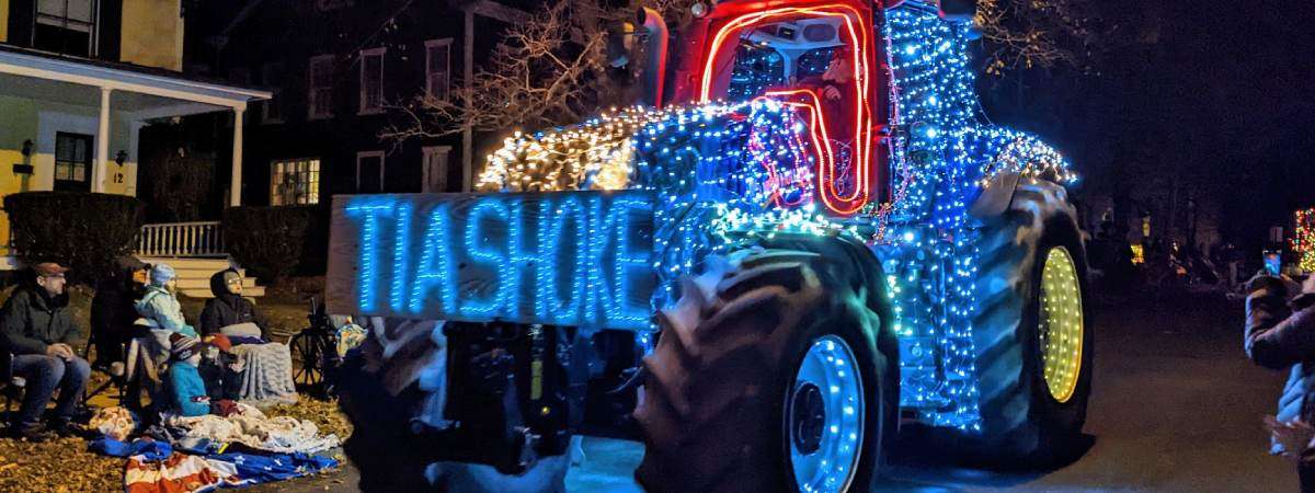 tractor in tractor parade with lights that spell out tiashoke