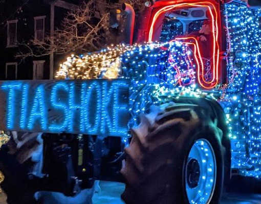 tractor in tractor parade with lights that spell out tiashoke