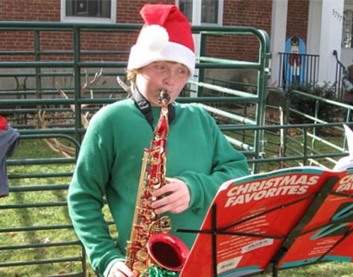 person playing saxophone in holiday costume