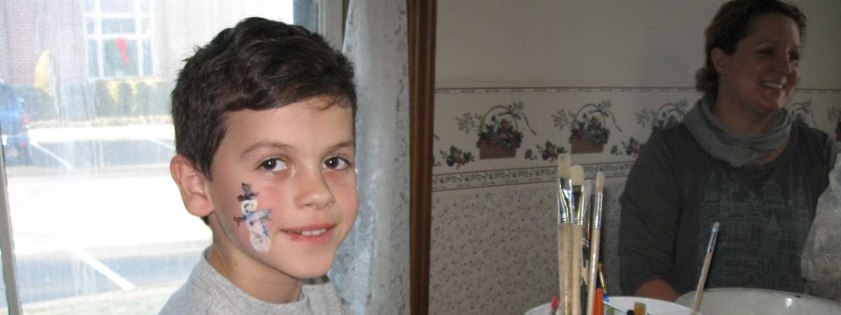 boy with holiday face paint and crafts