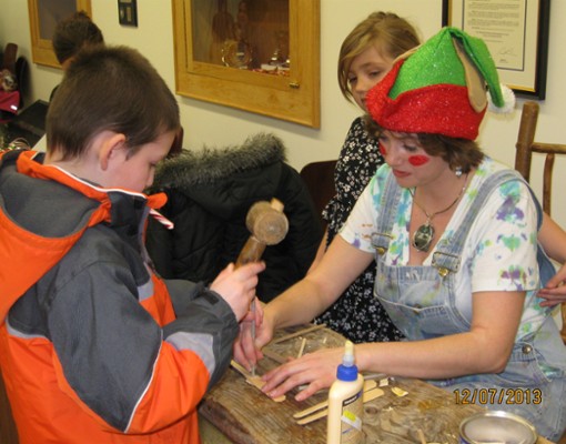 a woman dressed like an elf helping a boy