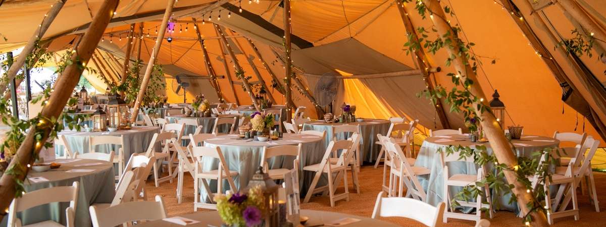 event table set up under elegant tent