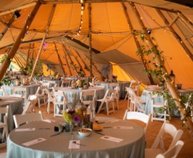 event table set up under elegant tent