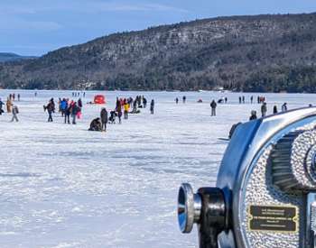 viewfinder looking at people on ice at lake george winter carnival