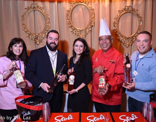 five people holding bottles of vodka