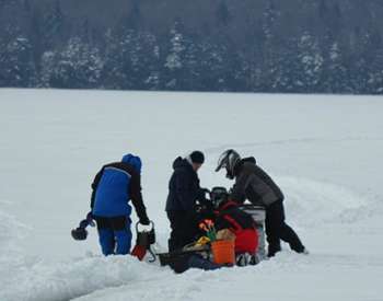 group of people moving ice fishing gear