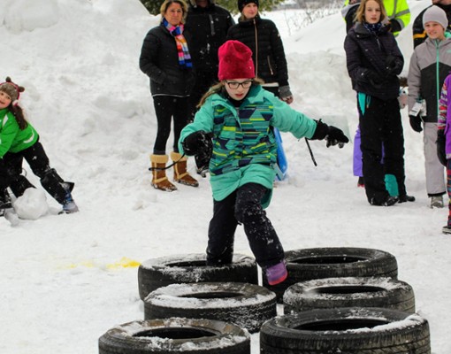 kid in obstacle course in snow
