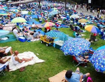 Large crowd sitting on the grass for the jazz festival at SPAC