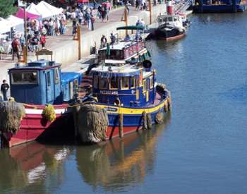 a blue tugboat sitting in the water