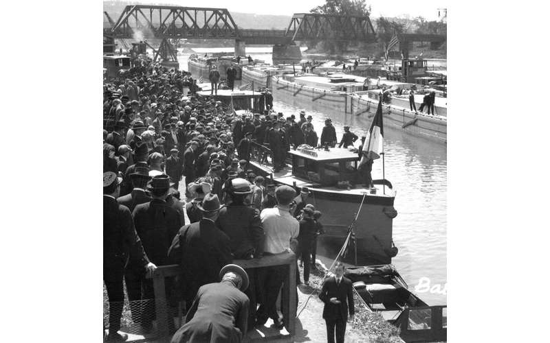 black and white image of people near the canal