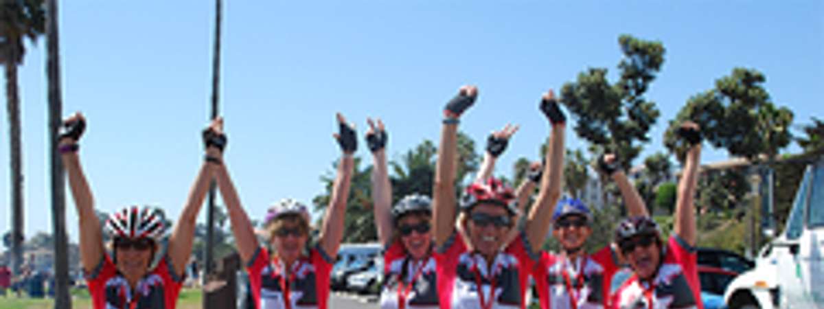 bicycle riders with arms raised