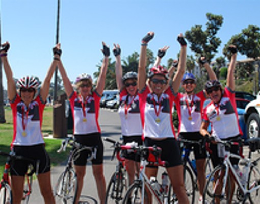 bicycle riders with arms raised