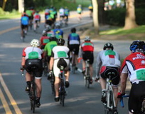 bicyclists riding down a road