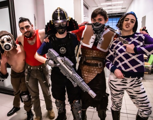 five people dressed up at comic con