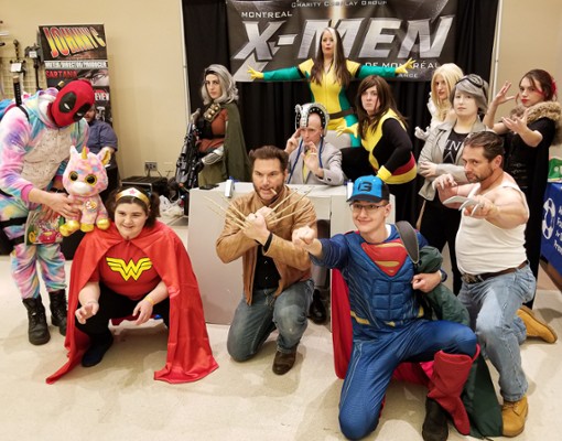 people dressed as superheroes at comic con