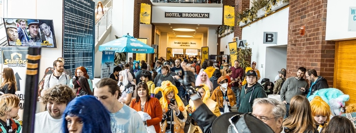 people dressed as superheroes at comic con