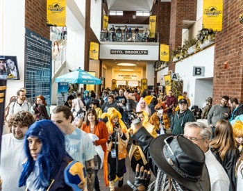 people dressed as superheroes at comic con