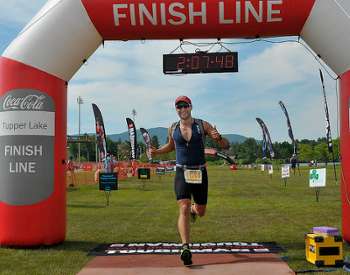 male racer crossing the finish line