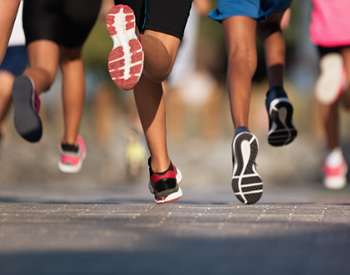 the back of young feet running in a race