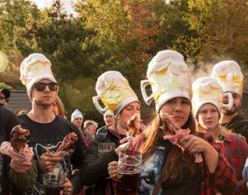 people in beer hats with chicken