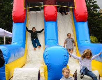 kids in bounce house slide